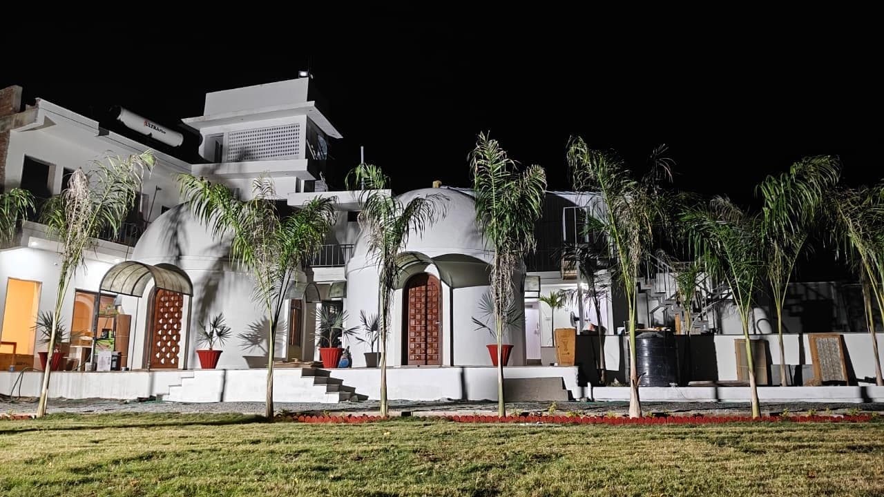 Palm Villa resort at night with palm trees